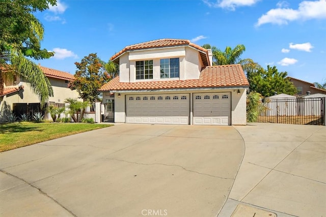 mediterranean / spanish home featuring a front yard and a garage