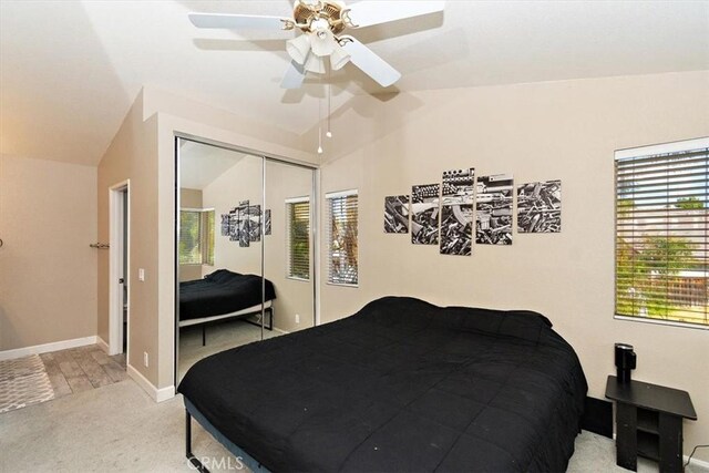 bedroom with carpet, lofted ceiling, ceiling fan, and a closet