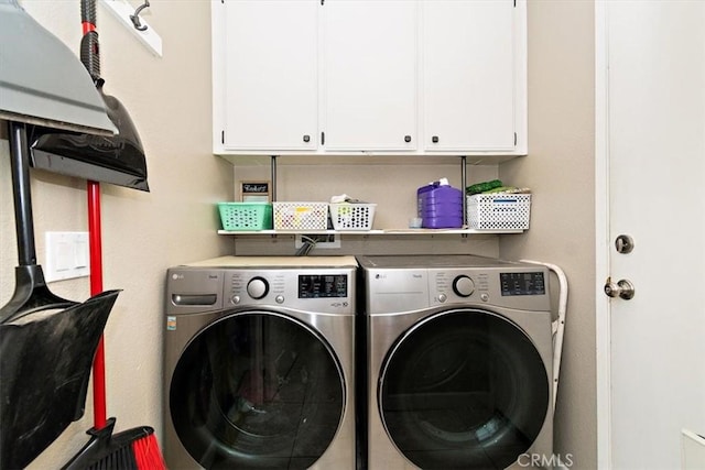 laundry area featuring cabinet space and washing machine and clothes dryer