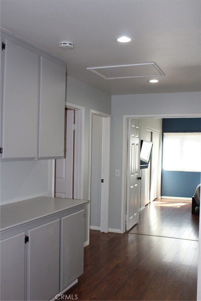 corridor with dark hardwood / wood-style flooring