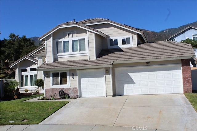 view of property with a garage, a mountain view, and a front yard