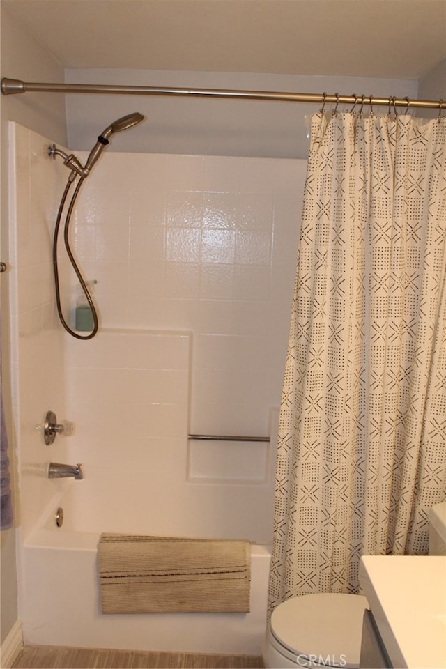 full bathroom featuring shower / tub combo, vanity, and toilet