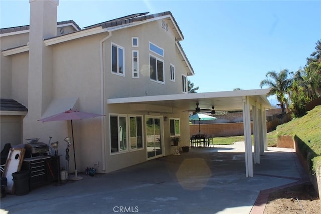 rear view of property with a patio and ceiling fan