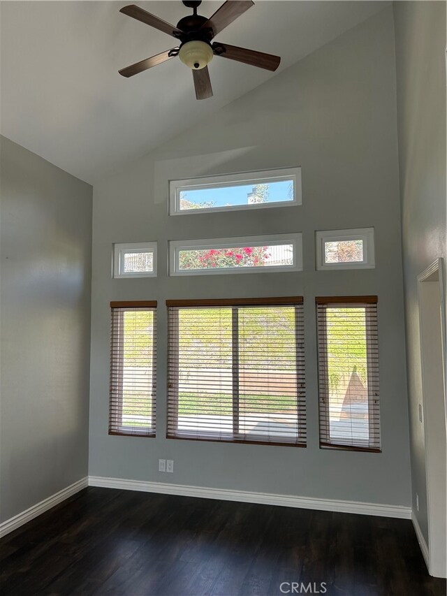 unfurnished room featuring ceiling fan, dark hardwood / wood-style flooring, and high vaulted ceiling