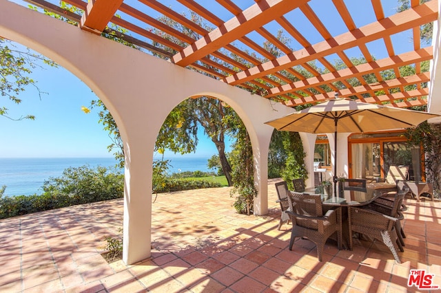 view of patio / terrace featuring a water view and a pergola