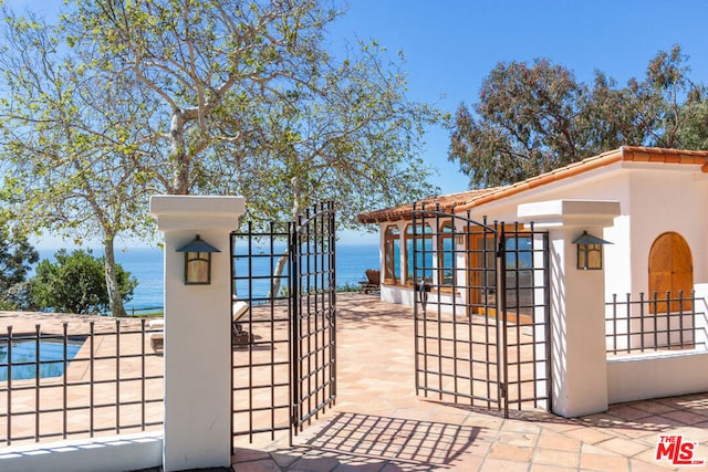 exterior space with a pool and a water view