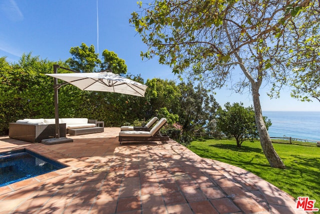 view of patio / terrace with a water view and outdoor lounge area