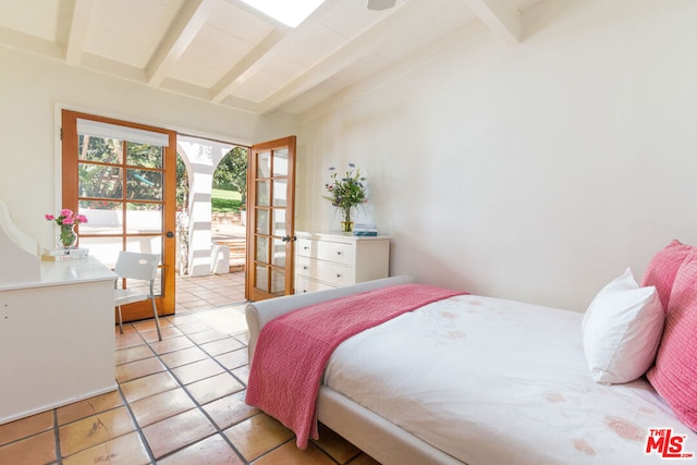 tiled bedroom with lofted ceiling with beams