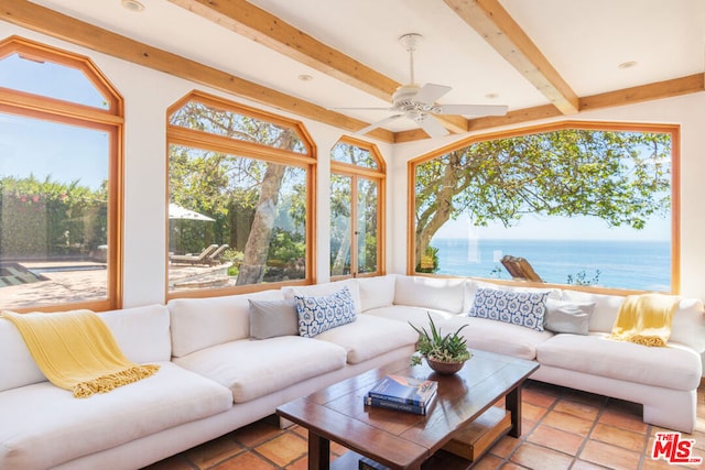 sunroom / solarium featuring a water view, beam ceiling, and ceiling fan