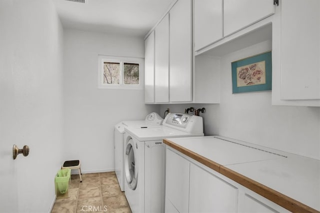 laundry area featuring cabinets and washing machine and clothes dryer