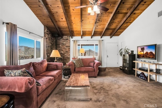 living room with wood ceiling, beam ceiling, a wood stove, carpet floors, and ceiling fan