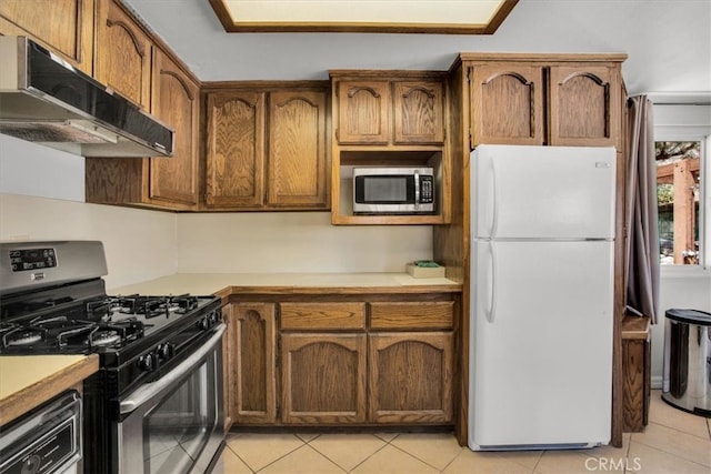 kitchen featuring appliances with stainless steel finishes and light tile patterned floors