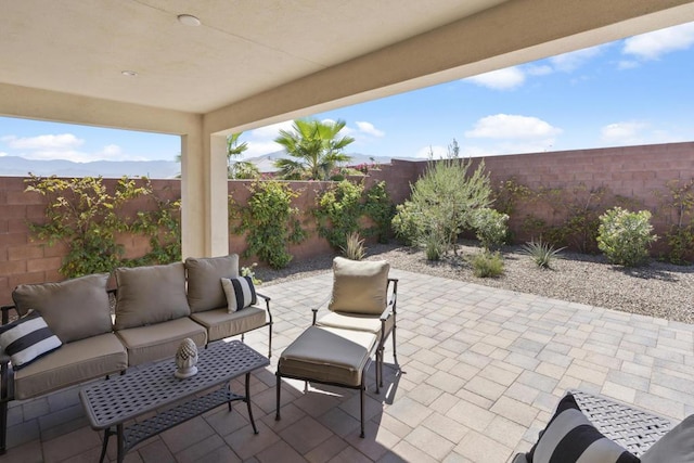 view of patio / terrace featuring an outdoor hangout area and a mountain view