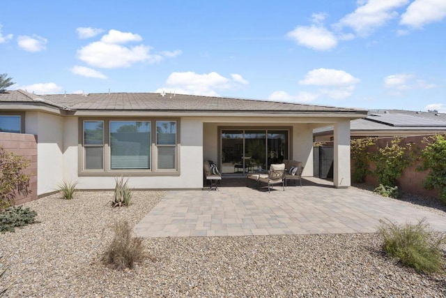 rear view of property featuring a patio