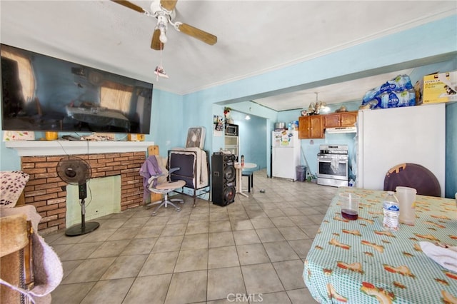 dining room featuring ceiling fan, ornamental molding, and light tile patterned flooring