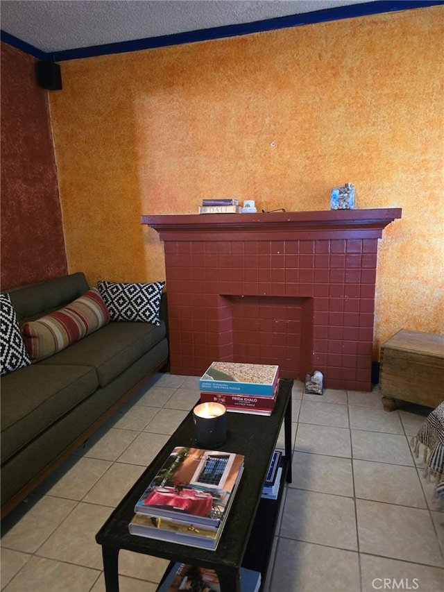 tiled living room featuring a fireplace, a textured ceiling, and ornamental molding