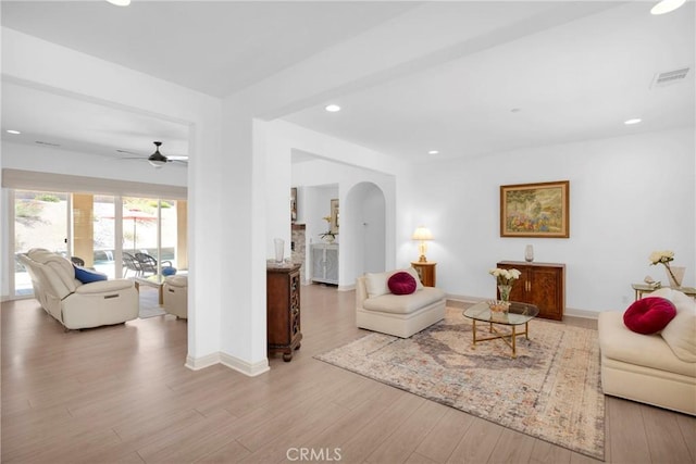 living room with light hardwood / wood-style flooring and ceiling fan