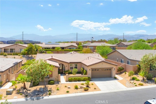 view of front of house with a mountain view and a garage