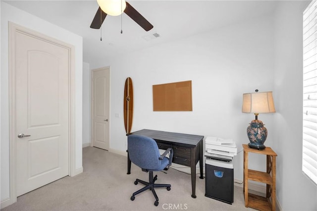 carpeted office space with ceiling fan