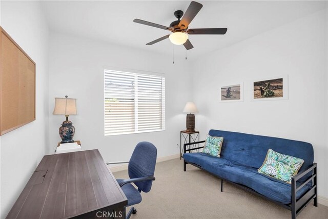 carpeted office space with ceiling fan