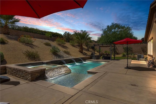 pool at dusk featuring an in ground hot tub, a patio area, central AC unit, and pool water feature