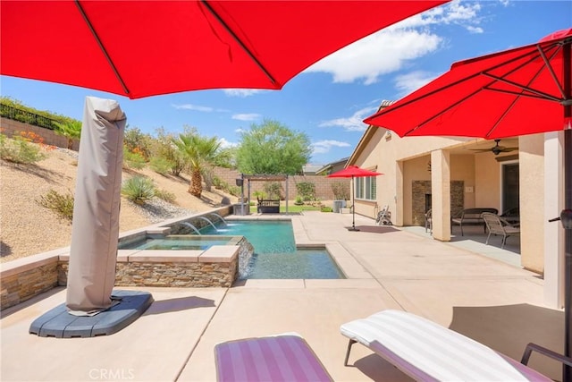 view of pool featuring pool water feature, an in ground hot tub, a patio, and ceiling fan