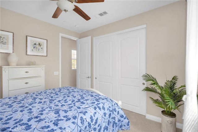 carpeted bedroom with a closet and ceiling fan