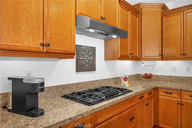 kitchen featuring light stone countertops and black gas stovetop