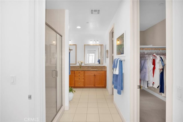 bathroom featuring vanity, tile patterned floors, and an enclosed shower