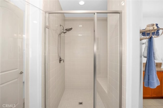 bathroom with tile patterned floors and an enclosed shower