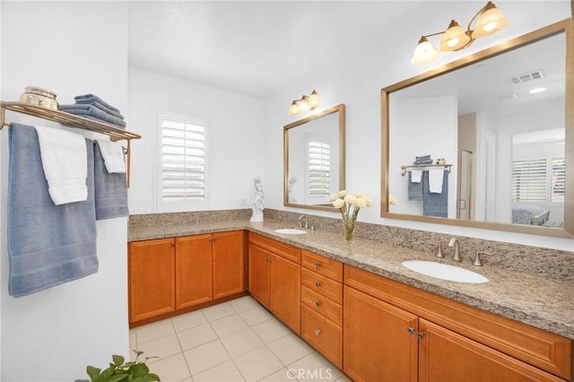 bathroom with tile patterned flooring and vanity