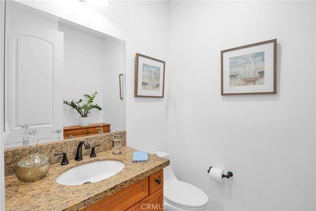 bathroom with vanity and toilet