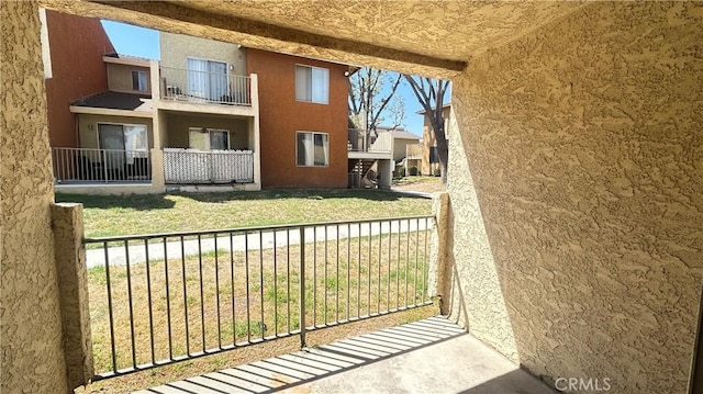 exterior space with a balcony and stucco siding