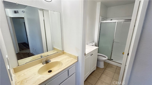 bathroom with walk in shower, vanity, tile patterned flooring, and toilet