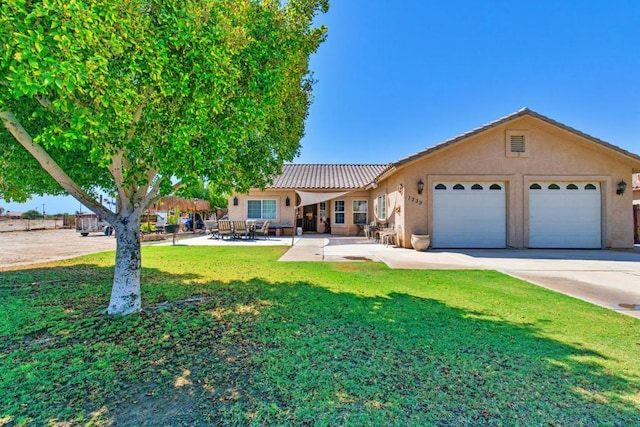 view of front of property with a garage and a front lawn