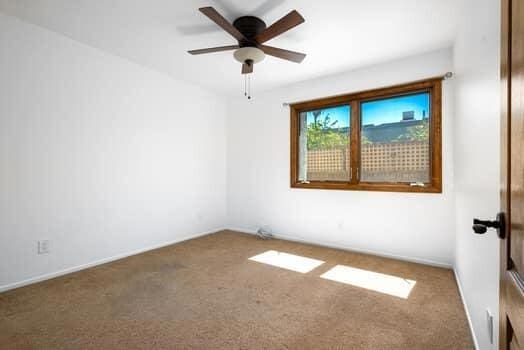 empty room with carpet and ceiling fan