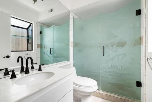 bathroom with vanity, tile patterned flooring, toilet, and a shower with door