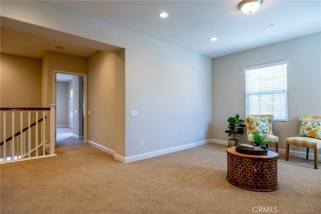 sitting room featuring light colored carpet