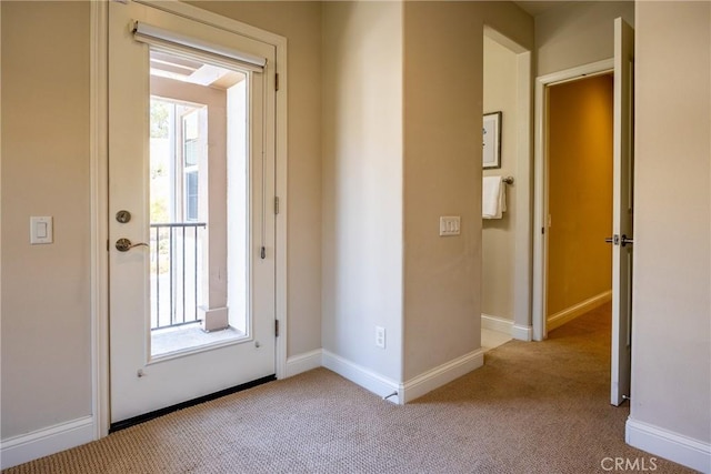 doorway to outside featuring light colored carpet and plenty of natural light