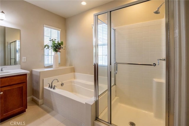 bathroom with tile patterned floors, vanity, and separate shower and tub