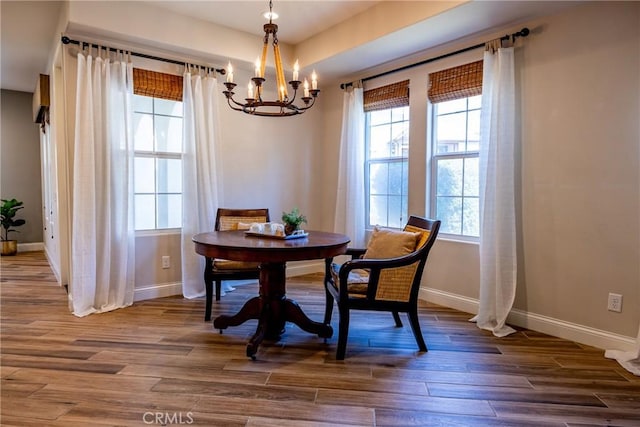 dining room featuring a notable chandelier and dark hardwood / wood-style flooring