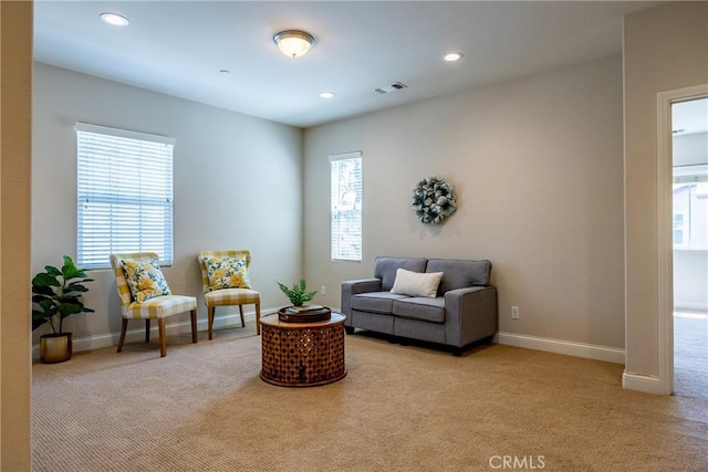 sitting room with light colored carpet