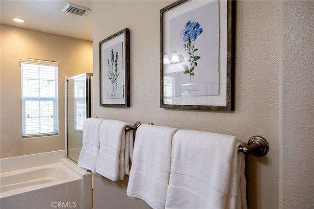 bathroom with a relaxing tiled tub