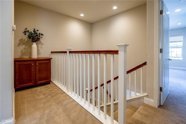 corridor with light colored carpet