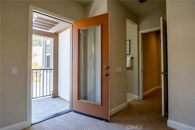 doorway to outside with carpet