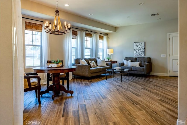 living room with hardwood / wood-style flooring and a chandelier