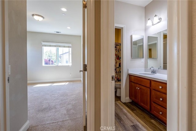 bathroom with a shower with curtain, vanity, and toilet