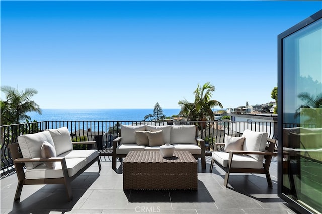 view of patio / terrace featuring a balcony, a water view, and outdoor lounge area