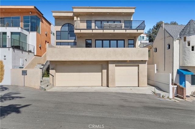 view of front of house featuring a balcony and a garage