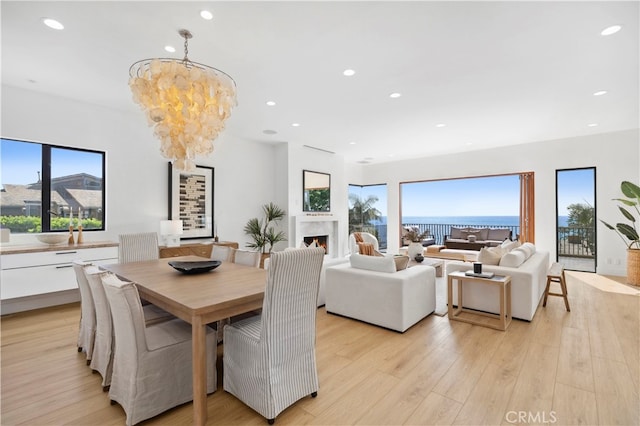 dining room featuring an inviting chandelier and light wood-type flooring